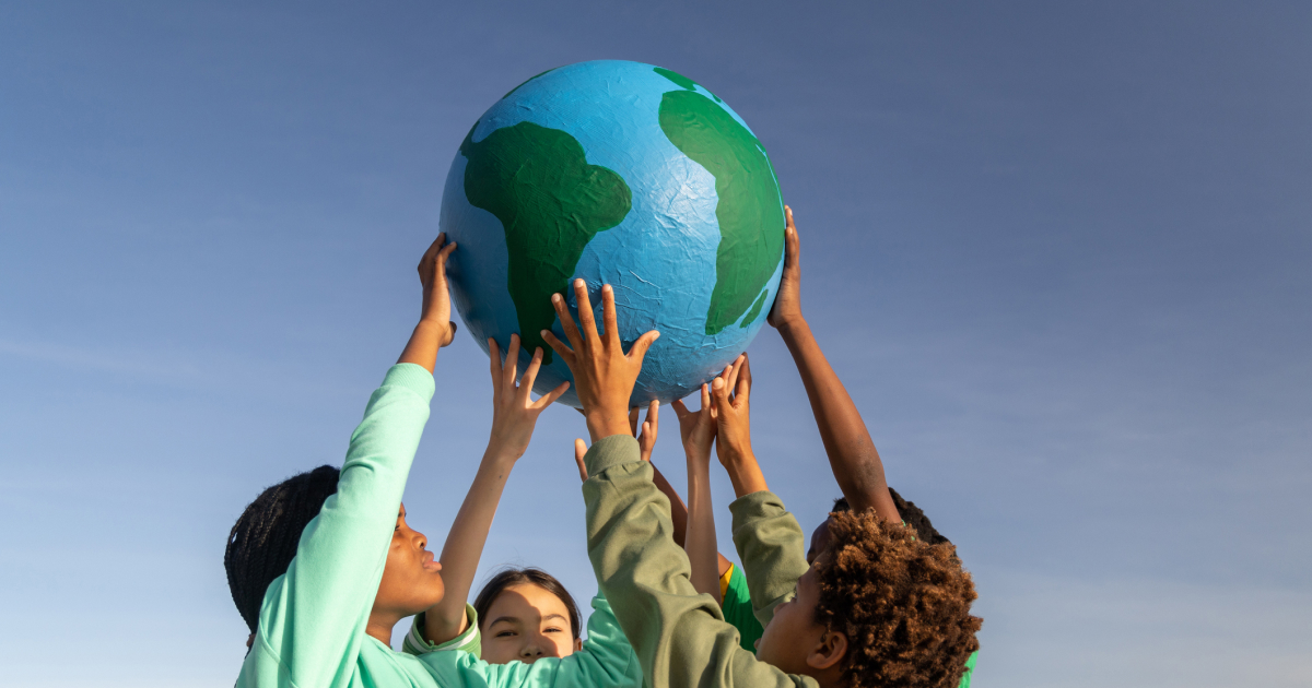 students lifting up a globe